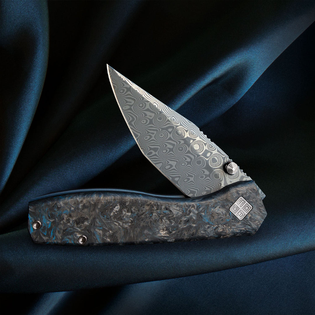 Delos Damascus knives Dark Matter Blue on cloth