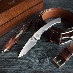 Seaton knife on desk with pen and belt